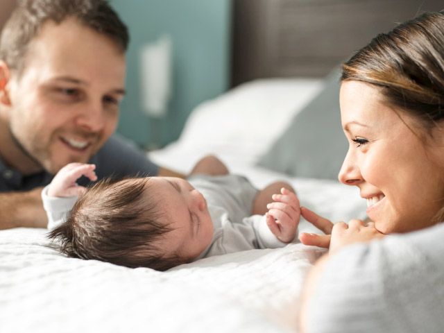 Two Parents Around Their New Born Baby Two Parents Around Their New Born Baby